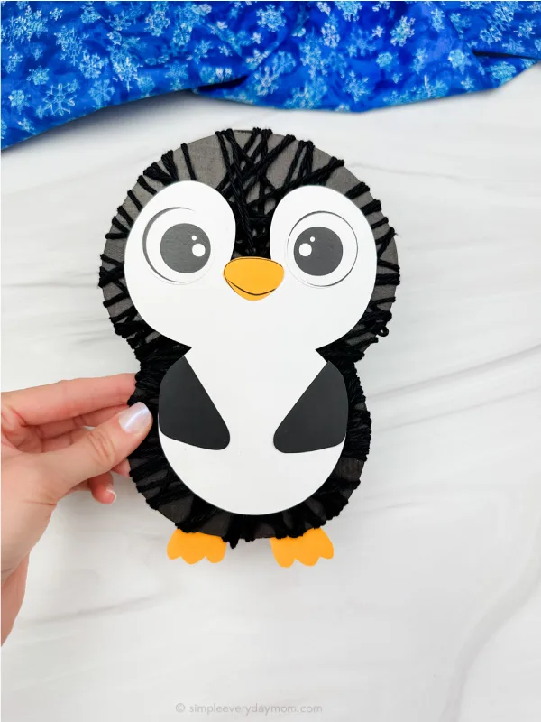 holding the yarn penguin craft image
