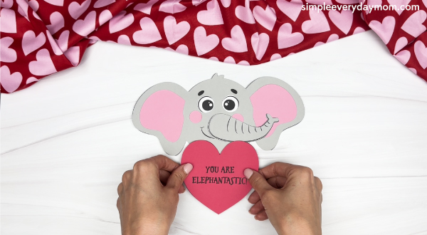 hand gluing the heart of the elephant valentine craft