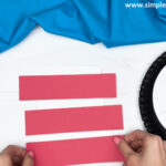 creating a hat with three red stripes.