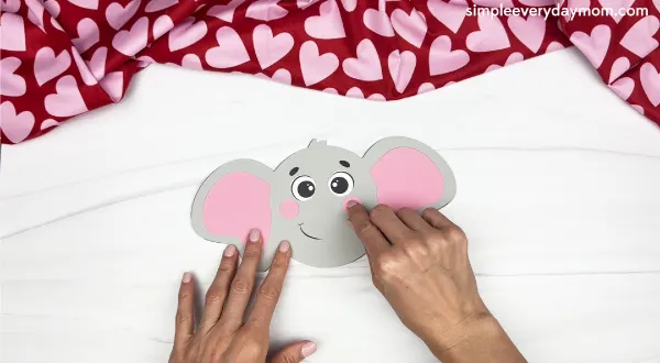 hand gluing the cheeks of the elephant valentine craft