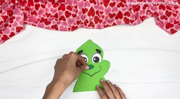 handgluing the nose of the grinch valentine craft