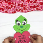 hand gluing the heart of the grinch valentine craft