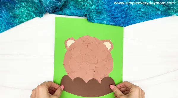 handgluing the rocks of the torn paper groundhog craft
