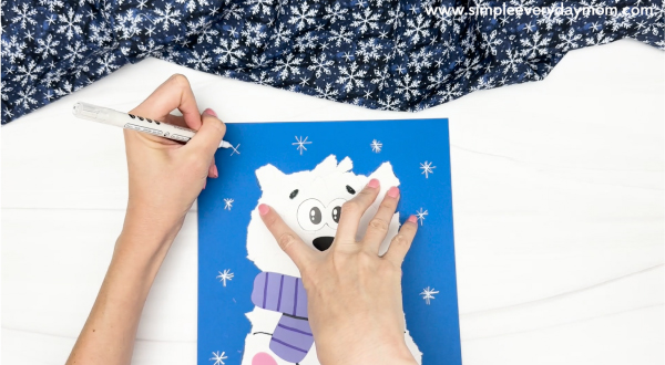 hand drawing the snowflakes on background paper