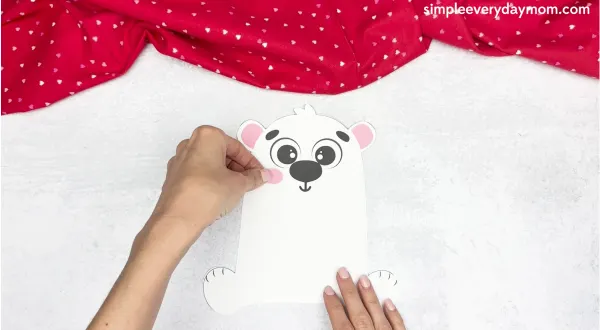 hand gluing the cheeks of the polar bear valentine craft