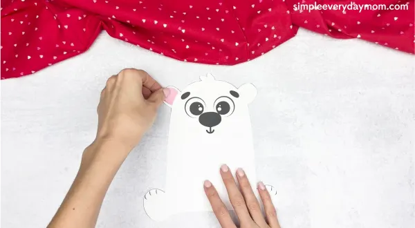 hand gluing the inner ears of the polar bear valentine craft