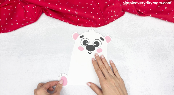 hand gluing the pink food pads of polar bear valentine craft