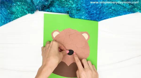 hand gluing the nose of the torn paper groundhog craft