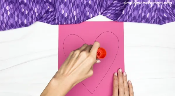 spreading glue to heart craft