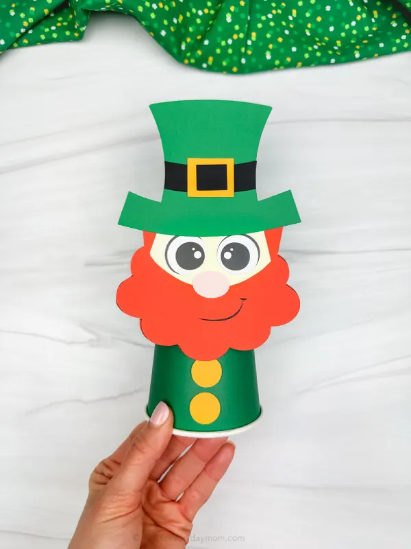 hand holding the cute leprechaun paper cup craft