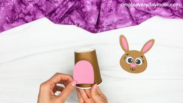 hand gluing belly of Bunny Paper Cup Craft