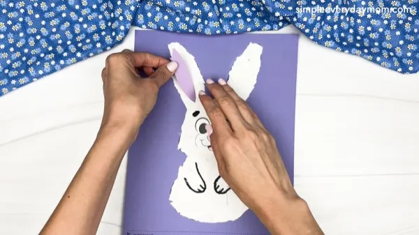hand gluing the inner ear of the torn paper bunny craft