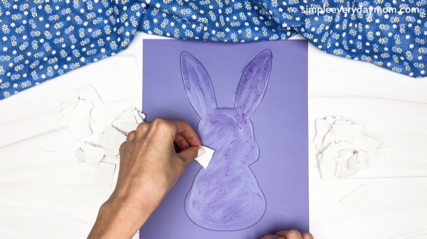 hand painting the body of the torn paper bunny craft