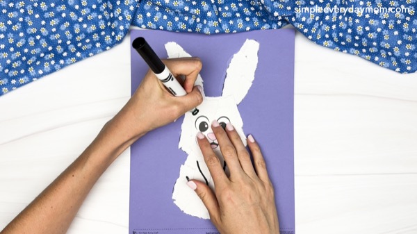 hand drawing the eyebrow of the torn paper bunny craft