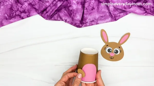 hand gluing arms of Bunny Paper Cup Craft