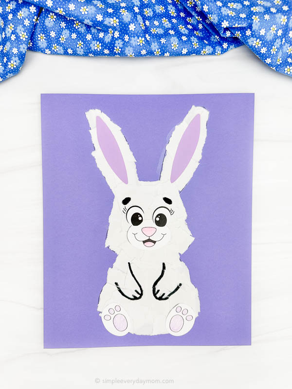 single example of finished torn paper bunny craft with green fabric at the top 