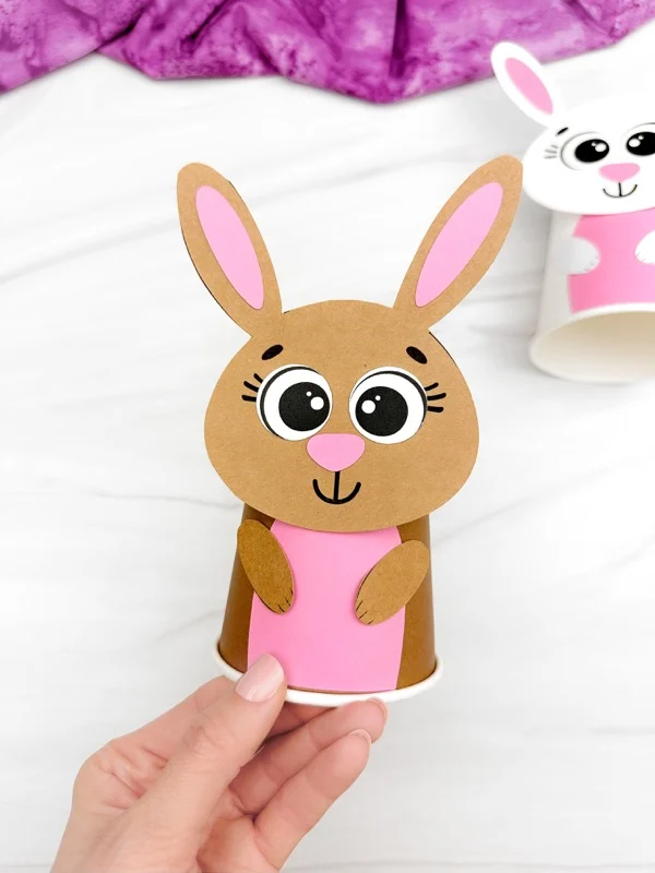 hand holding single example finished Bunny Paper Cup Craft