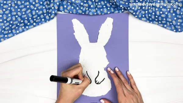 hand drawing the arms of the torn paper bunny craft