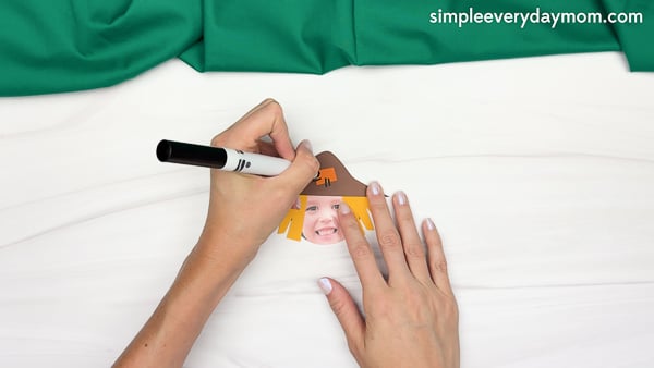 Hand drawing the stitching marks of the Scarecrow Photo Craft