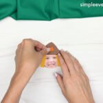 Hand gluing the patch of the Scarecrow Photo Craft
