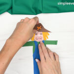 Hand gluing the head of the Scarecrow Photo Craft