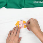 Hand gluing the picture of the Scarecrow Photo Craft