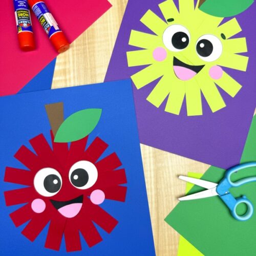 Two finished paper strip apple crafts, one red and one green, displayed on blue and purple backgrounds with smiling faces, surrounded by craft supplies like glue sticks, scissors, and colored paper.