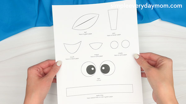Printable apple core craft template with cut-out shapes for eyes, stem, leaf, cheeks, and mouth. Perfect for a fun and easy fall craft activity for kids.
