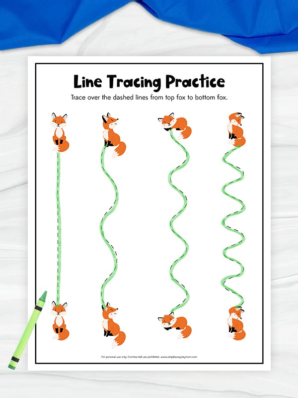 A children’s worksheet titled “Line Tracing Practice” features pairs of cartoon foxes at the top and bottom of the page, with various dashed vertical lines between them for kids to trace using a green crayon.