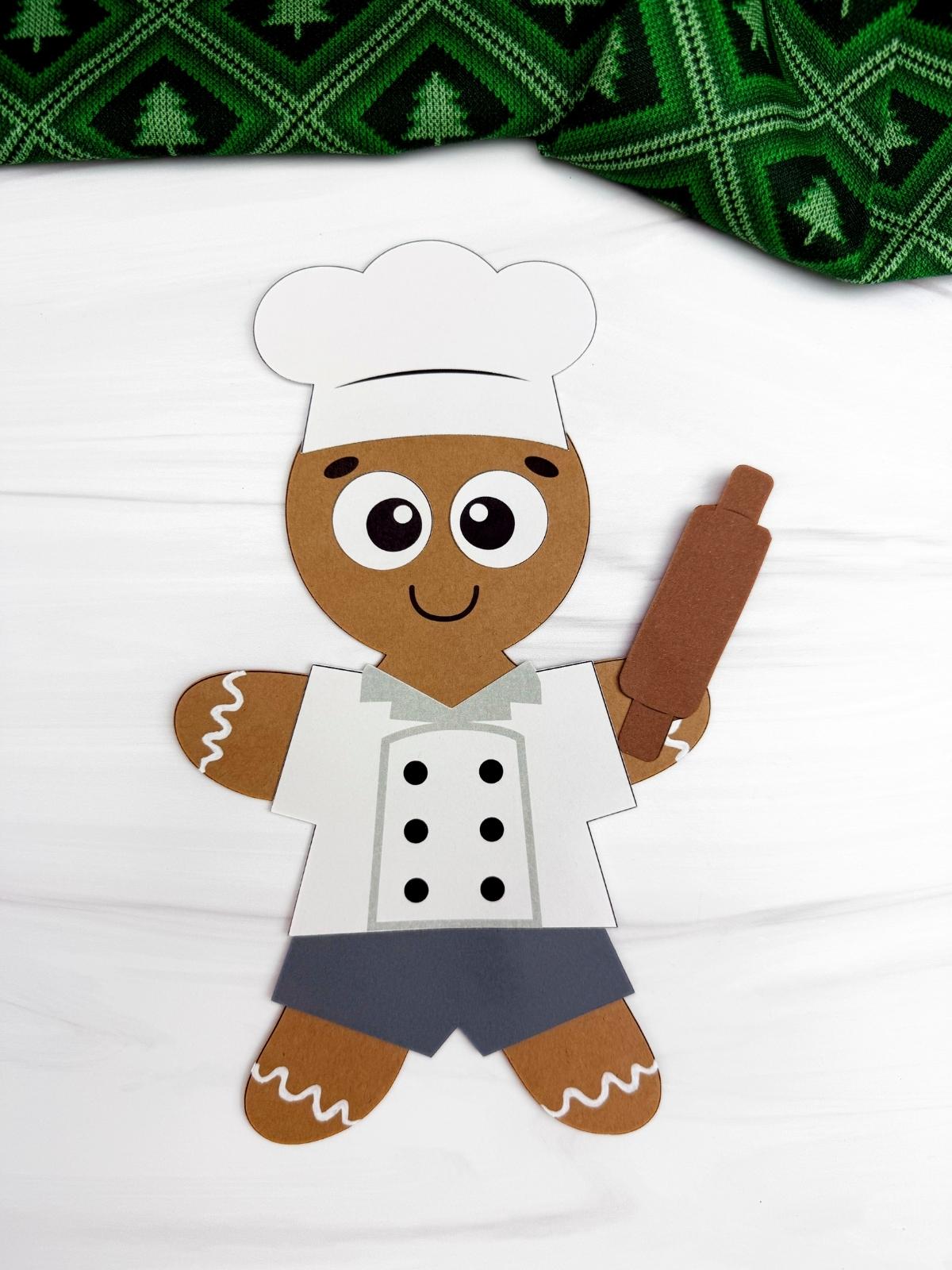 A completed Craft showing a chef gingerbread man disguise with a chef hat, white apron, rolling pin, and icing details, perf