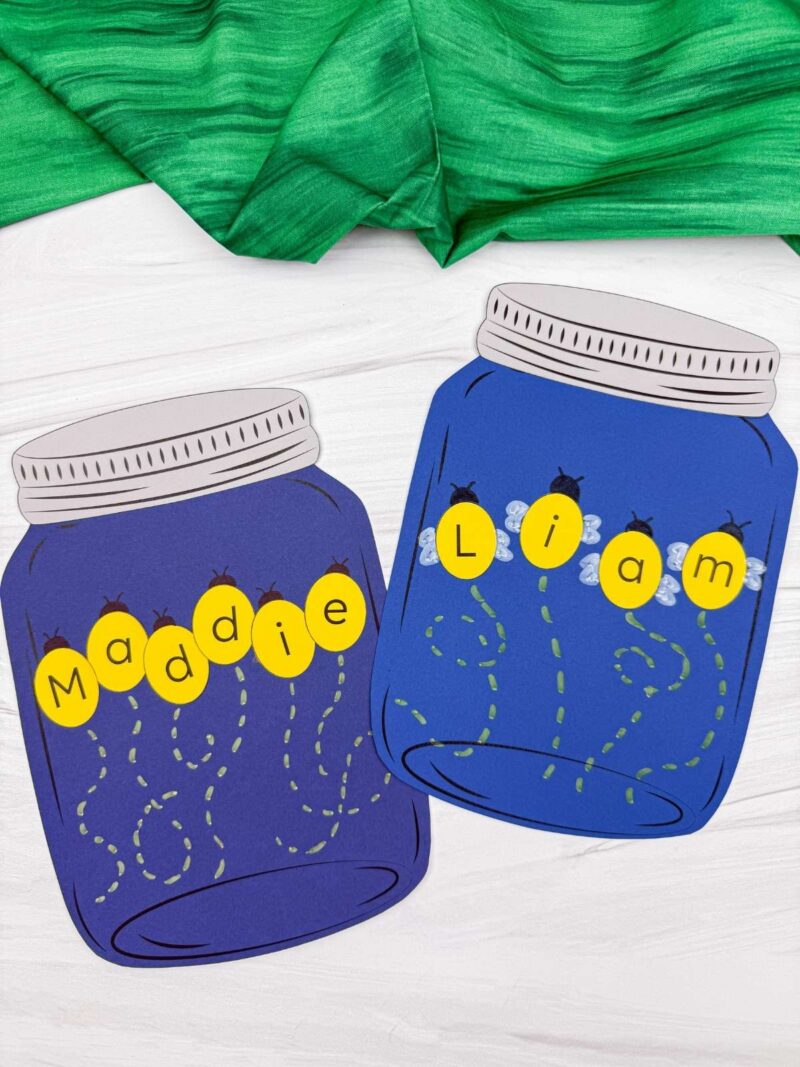 A completed craft showing two mason jar firefly name crafts with names Liam and Maddie