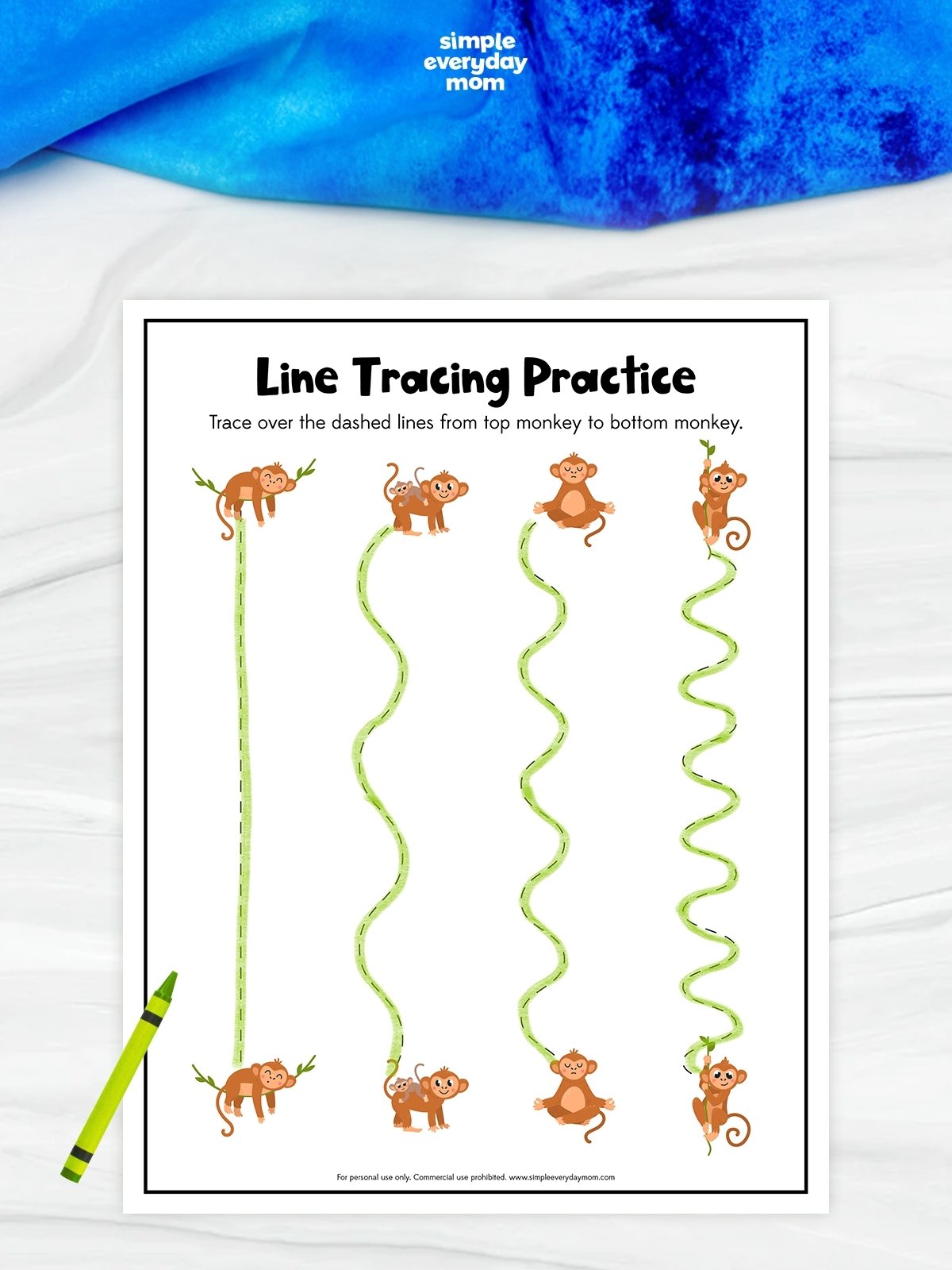 This image shows a preschool “Line Tracing Practice” worksheet with monkey characters. Children are instructed to trace over dashed lines from the top monkey to the matching monkey at the bottom. The worksheet includes four tracing paths with increasing curves and waves, helping kids practice pencil control and fine motor skills. A green crayon is placed beside the page, and the playful monkey illustrations make the activity engaging for young learners.
