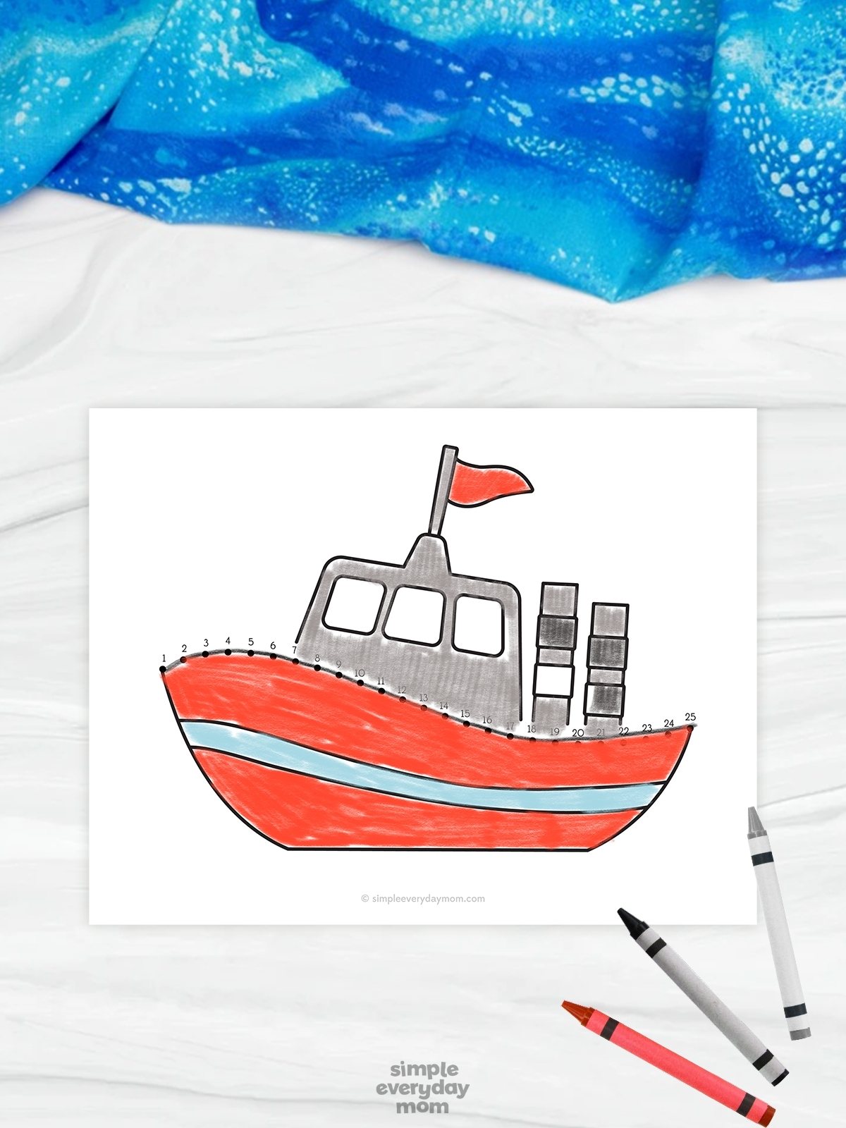 The image shows a beach-themed connect-the-dots worksheet featuring a red boat with a gray cabin and a small red flag on top. Numbered dots trace along the top edge of the boat, helping children practice counting, tracing, and fine motor skills while completing the picture. The worksheet is displayed on a light marble-style background with crayons and a blue fabric accent, creating a bright and playful educational activity for kids.