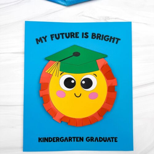 A completed craft sun graduation card with a smiling sun wearing a green graduation cap and “My Future Is Bright” text on blue paper