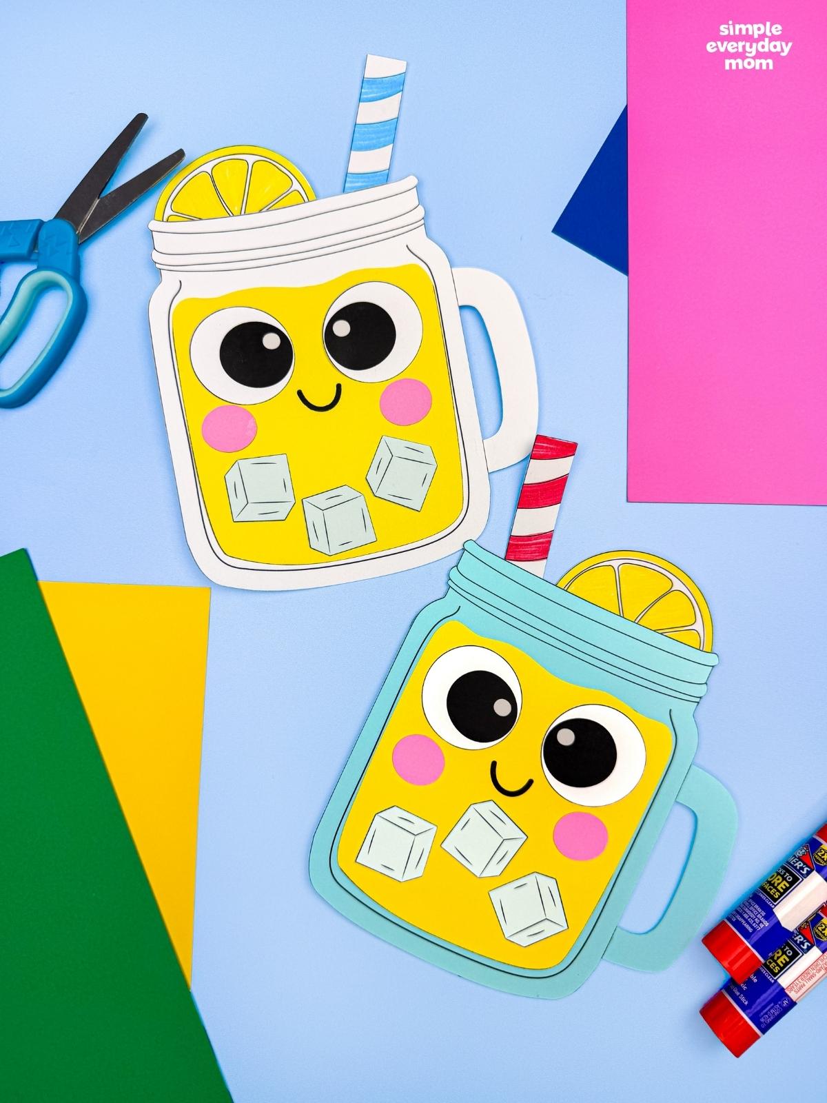 A completed lemonade paper craft with smiling mason jars, striped straws, lemon slices, and colorful craft supplies.