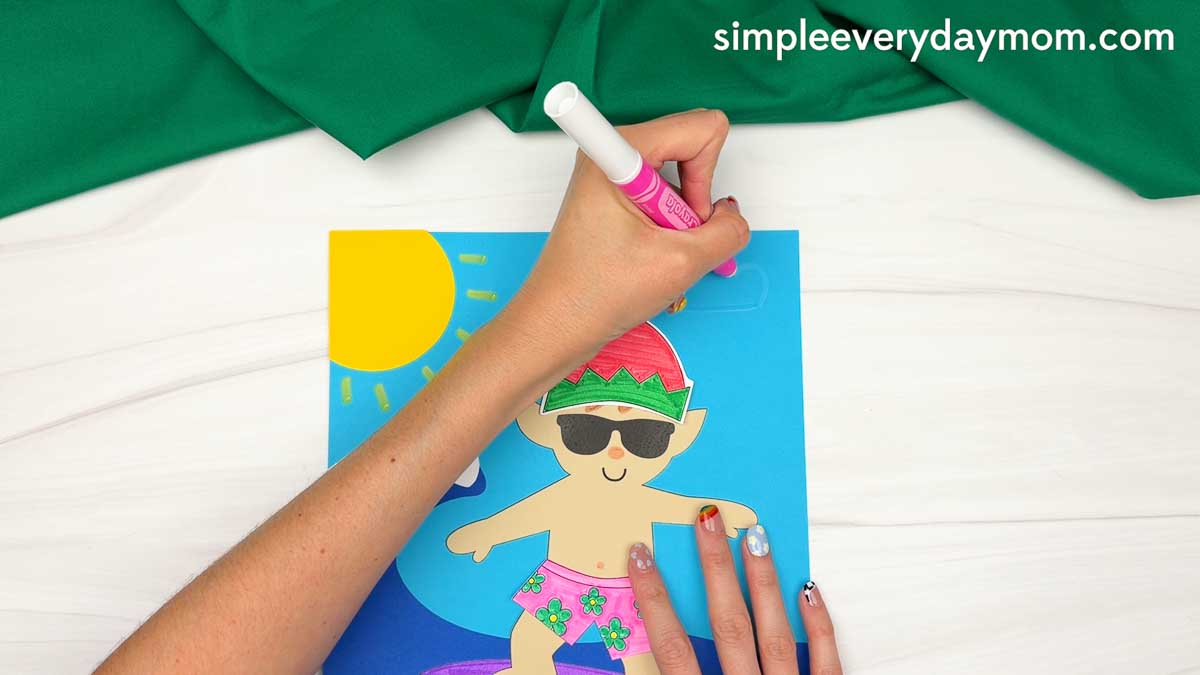 Hands drawing a white cloud above the surfing elf ocean scene for an elf surfing craft.
