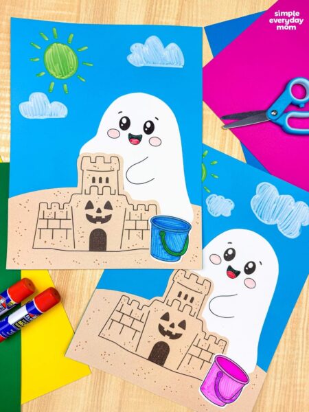 A completed Craft featuring two beach ghost scenes with smiling ghosts, sandcastles, colorful beach buckets, and sunny skies, displayed with craft supplies.