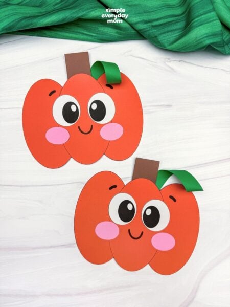 A completed Craft showing two smiling Pumpkin Shape Craft designs with different vine and leaf placements.