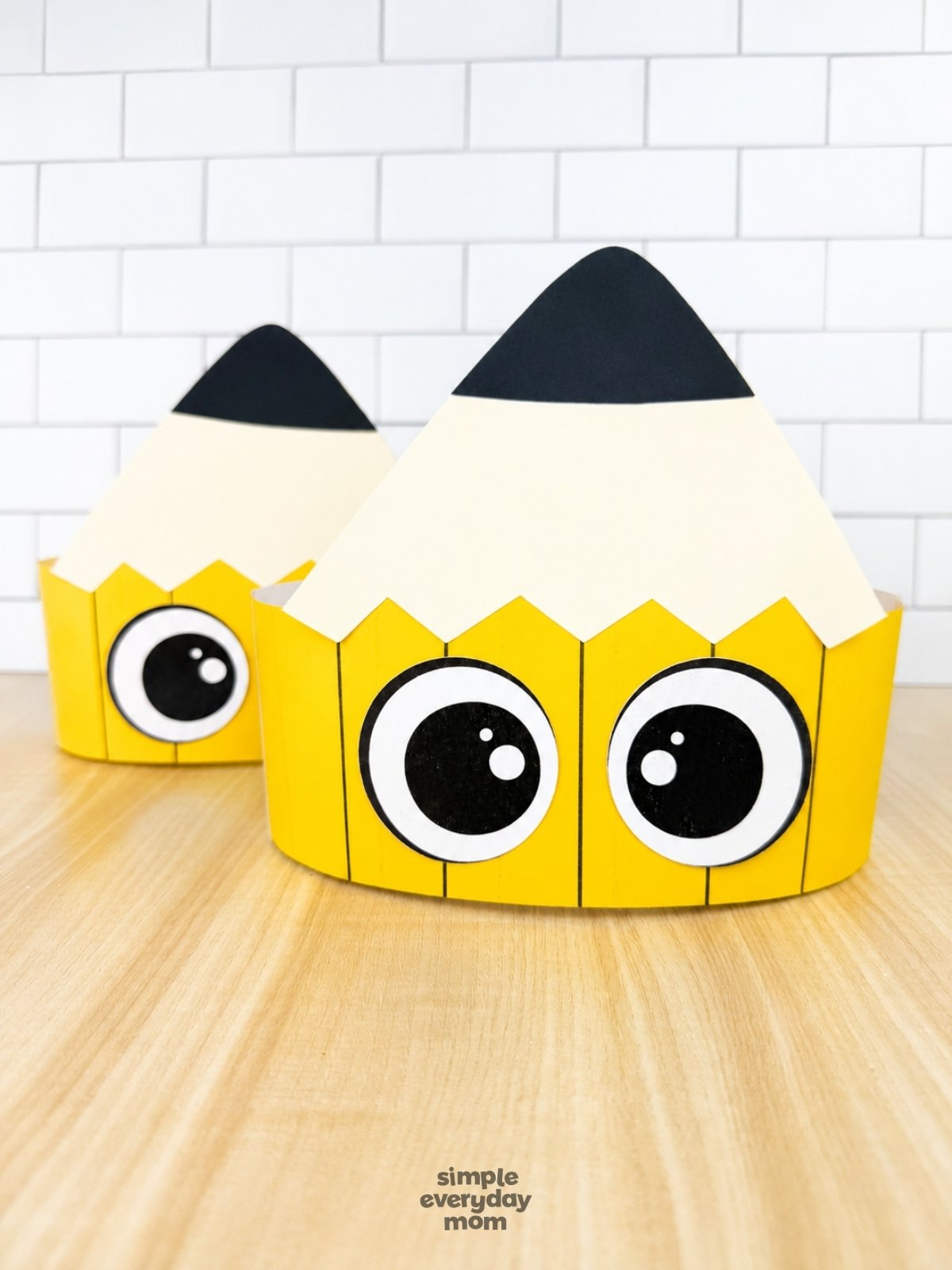 A completed craft of two printable pencil headbands displayed together on a tabletop.