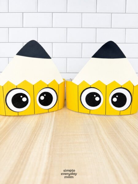 A completed craft of two printable pencil headbands displayed side by side on a tabletop.