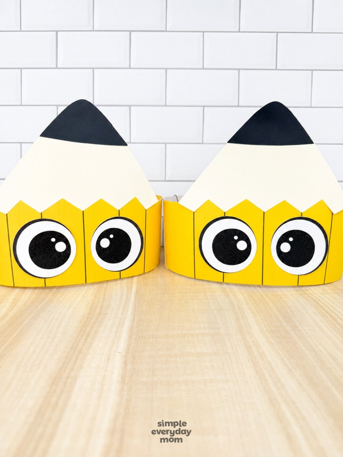 A completed craft of two printable pencil headbands displayed side by side on a tabletop.