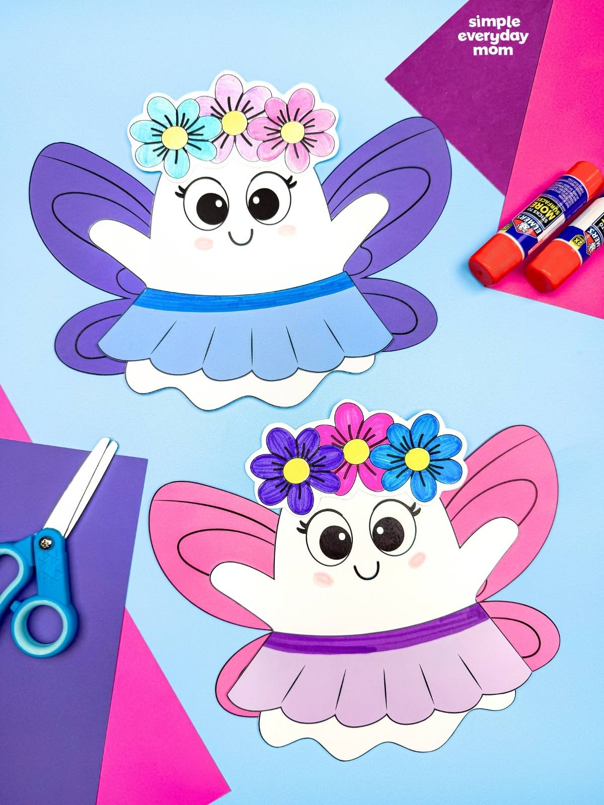 A completed craft of two Fairy Ghost Disguise Craft designs with different colored fairy wings, flower crowns, and skirts displayed with craft supplies.