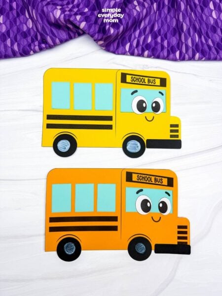 A completed craft showing two finished bus shape crafts in different colors with smiling school bus faces.