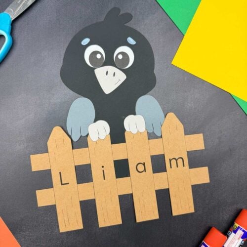 A completed Craft showing a crow perched behind a personalized name fence spelling Liam.