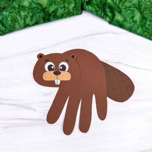 A completed Beaver Handprint Craft with a paper handprint body, beaver face, and textured tail.