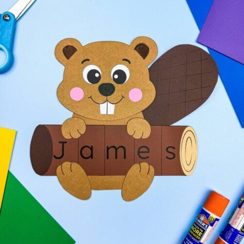 A completed craft showing a beaver holding a log that spells the name James.