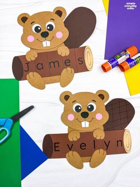 Side by side completed Beaver Name Crafts showing beavers holding personalized logs that spell James and Evelyn.