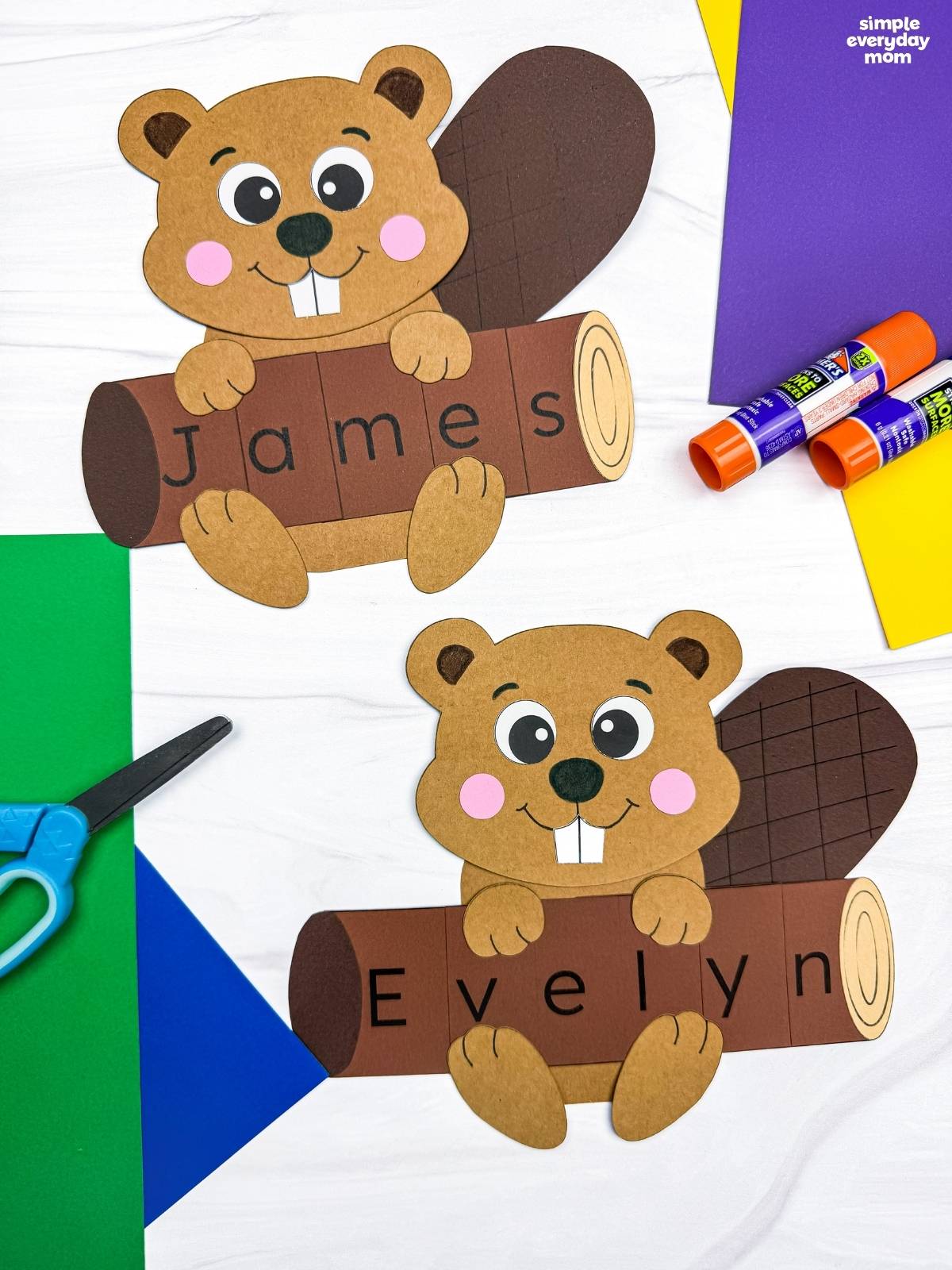Side by side completed Beaver Name Crafts showing beavers holding personalized logs that spell James and Evelyn.