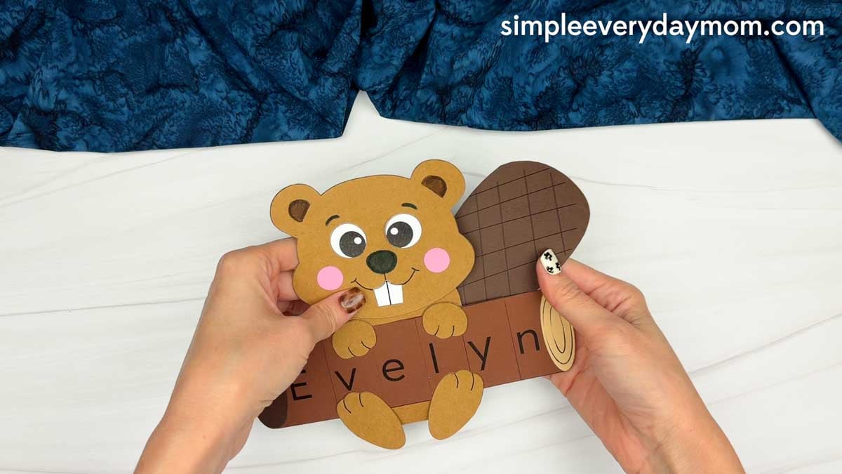 Hands holding the Beaver Name Craft with the tail attached behind the beaver.