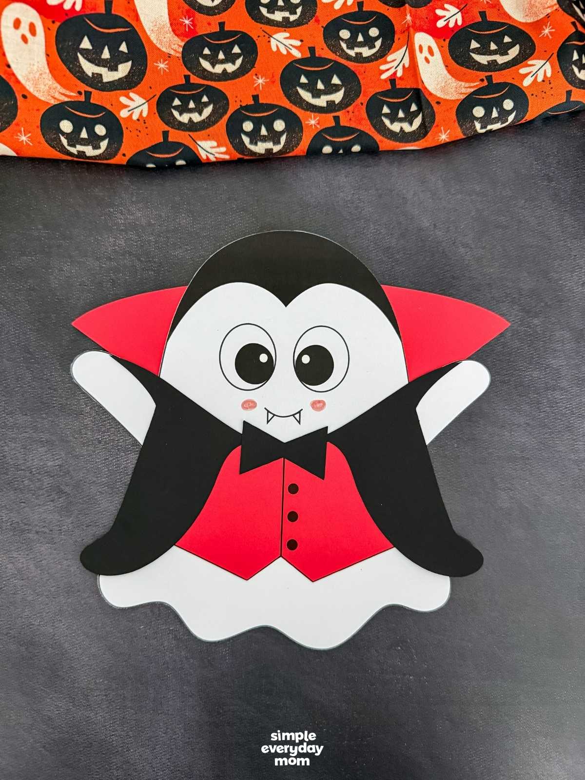 A completed craft of the Vampire Ghost Disguise Craft featuring a vampire cape, collar, bow tie, and vest.